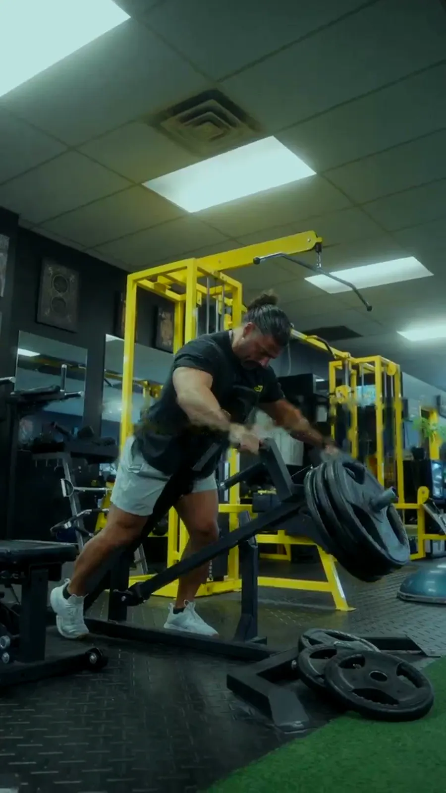 Athlete loading plates in the weight room